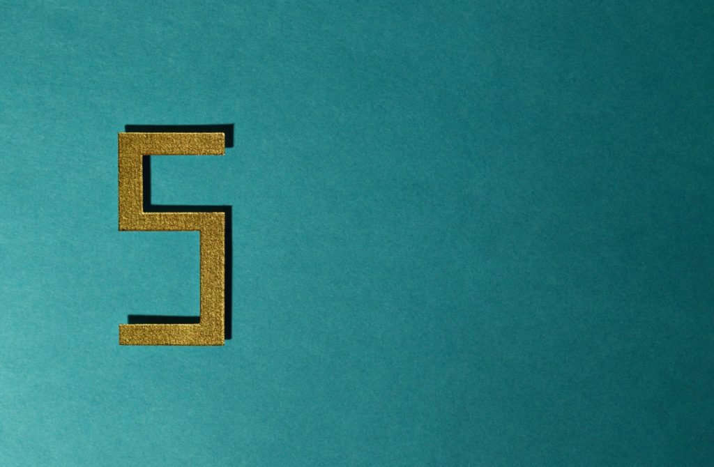 Gold number 5 on teal background