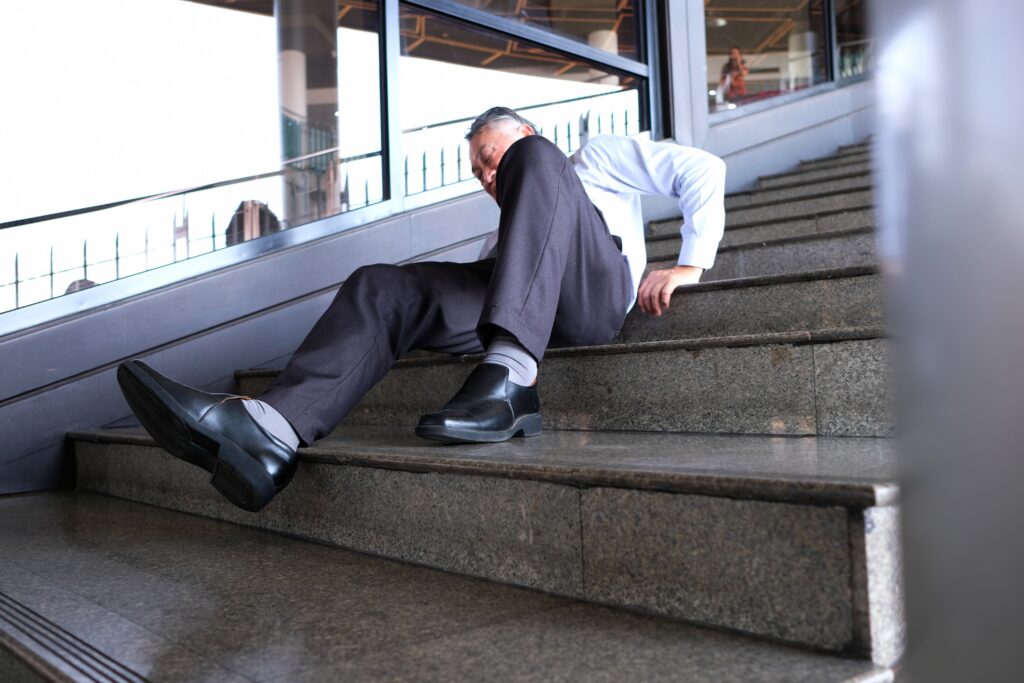 Man lying on the staircase after a slip and fall accident